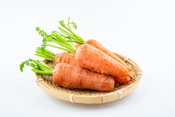 Fresh carrots in a pot on white background