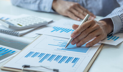 Financial Business man analyze the graph of the company's performance to create profits and growth, Market research reports and income statistics, Financial and Accounting concept.