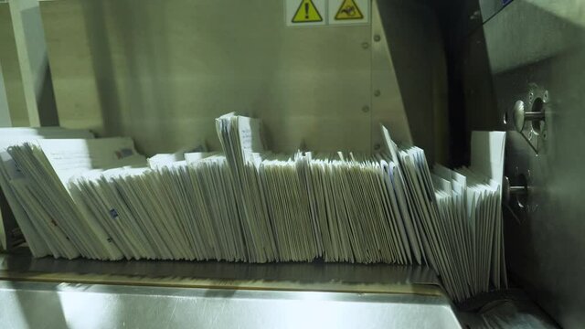 Sorting mail envelopes for a letter. Special equipment for sorting. Ready-made white envelopes for writing. Close-up