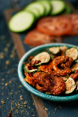 sliced dried tomato and zucchini, served as snack