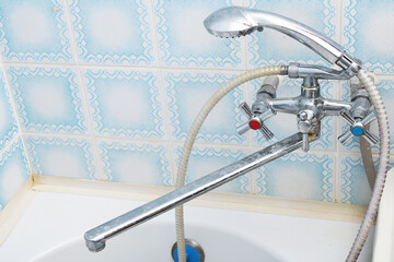 Dirty calcified shower mixer tap, faucet with limescale on it, close up