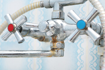Dirty calcified shower mixer tap, faucet with limescale on it, close up