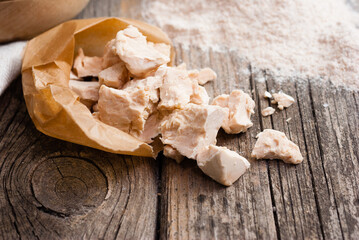 broken yeast cake on wax paper, weathered wood table background