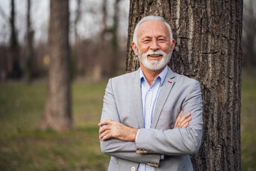 Outdoor portrait of happy senior businessman.