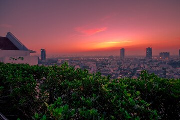 The high angle background of the city view with the secret light of the evening, blurring of night lights, showing the distribution of condominiums, dense homes in the capital community