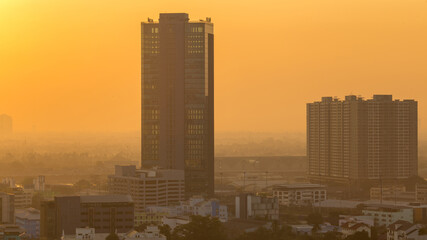 The high angle background of the city view with the secret light of the evening, blurring of night lights, showing the distribution of condominiums, dense homes in the capital community