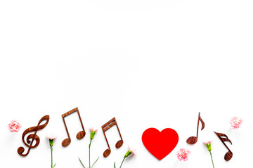 Flat lay of musical notes with flowers. Love songs concept