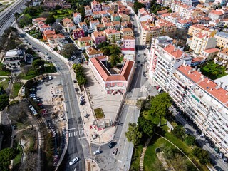 Aerial view of a small square in Alges residential district of Lisbon with colourful houses and city roads, Lisbon, Portugal. - obrazy, fototapety, plakaty