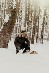 Obraz premium man walking corgi dog