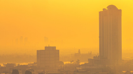The blurred abstract background of the morning sun exposure to the tiny dust particles that surround the tall buildings in the capital, the long-term health issue of pollution