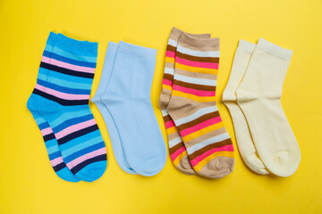 View from above. Socks are scattered on a yellow background. Clothing in the form of socks.