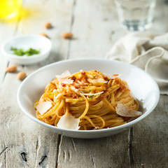 Spaghetti with red pesto sauce and cheese