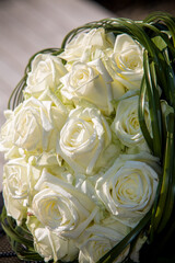 Beautiful white rose wedding bouquet with ribbon, closeup. Marriage concept. High quality photo