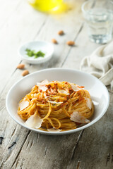 Spaghetti with red pesto sauce and cheese