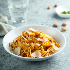 Spaghetti with red pesto sauce and cheese
