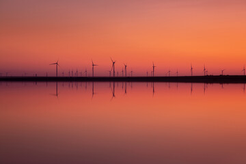 Plakat wind turbines at sunset. amazing landscape