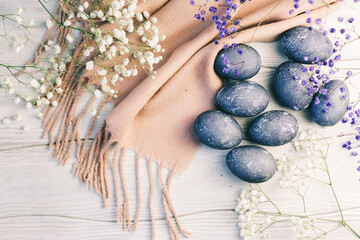 Fototapeta na wymiar Happy Easter card with blue eggs,flowers,feathers