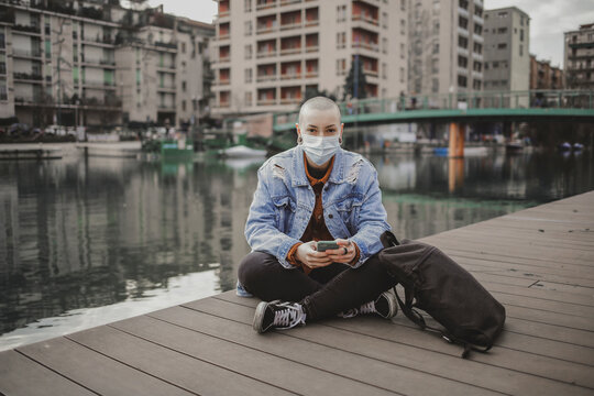 Alternative girl sitting near the river