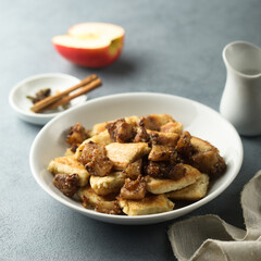 Traditional Austrian pancake dessert with apple and raisins