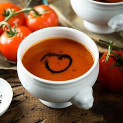 Homemade spicy tomato soup in a white bowl