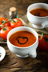 Homemade spicy tomato soup in a white bowl