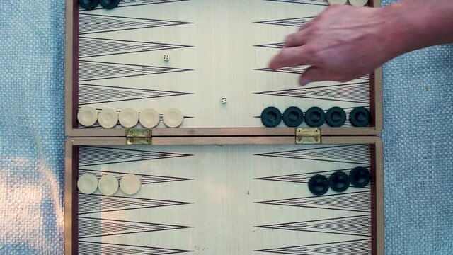 Two People Playing Backgammon. Turkish Traditional Board Game. Throwing Dice to Play. Natural Lighting Close Up Slow Motion Shot.