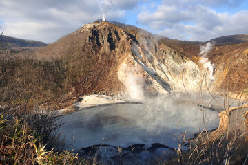 View of Oyunama pond at Jigokudani or Hell Valley, natural onsen hot spring tourist attraction at Noboribetsu, Hokkaido, Japan during winter.