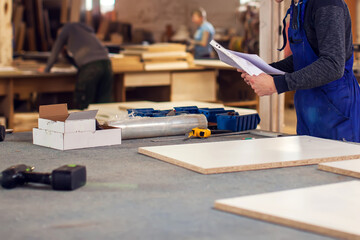 Production and manufacture of wooden furniture in furniture factory.