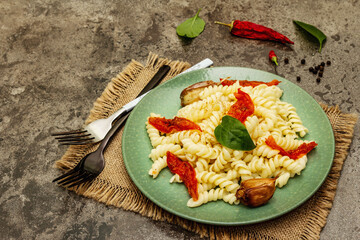 Gluten free fusilli pasta with baked garlic and tomatoes