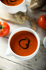 Homemade spicy tomato soup in a white bowl