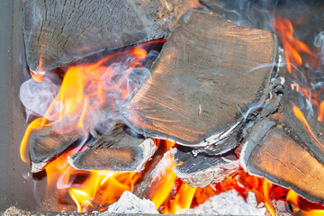 Dry wood burns brightly in the stove in the bath