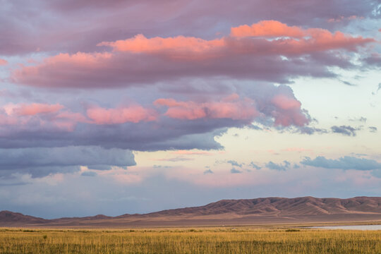 Amazing sunset sky with clouds under the steppe, Kazakhstan, Kegen