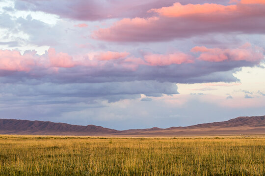 Amazing sunset sky with clouds under the steppe, Kazakhstan, Kegen