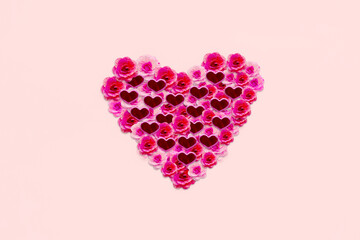 Paper flowers and knick knacks shaped heart symbol