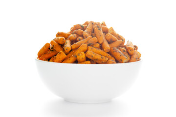 Spicy Chutney Sev in a white Ceramic bowl made with Chickpea flour and red chili. Pile of Indian spicy snacks (Namkeen), under backlight, Front view, against the white background.