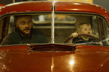 father and son in the old car