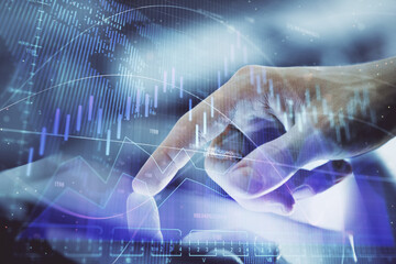 Multi exposure of man's hands holding and using a digital phone and forex graph drawing. Financial market concept.