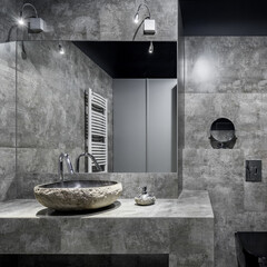 Dark bathroom with gray wall tiles