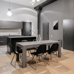 Big dining table with six chairs in loft