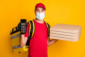 Portrait of guy wear safety mask bringing pizza boxes showing nfc machine stop mers cov pandemia isolated on vivid yellow color background