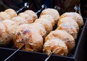 Close-up of outdoor champignon kebab with real charcoal, rustic grilled meat, barbecue. Spring