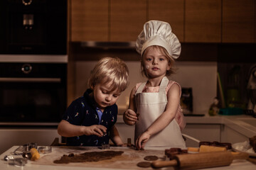 little boy and girl baking cookies