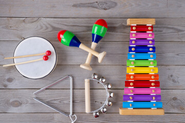 music accessories for children on wooden background. top view.