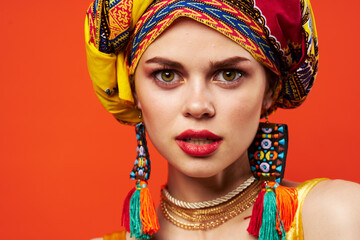 woman wearing multicolored turban decoration attractive look ethnicity red background