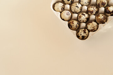 Quail eggs on a beige background. Top view. Easter decoration. Mockup. With copy space for text  