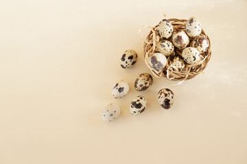 Quail eggs on a beige background. Top view. Easter decoration. Mockup. With copy space for text  