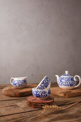Traditional Asian Tea Set - ceramic teapot and teacups for tea ceremony on a wooden table. Vintage style. With space for text. China, tea, tableware, tradition, health, tea ceremony, Asia.