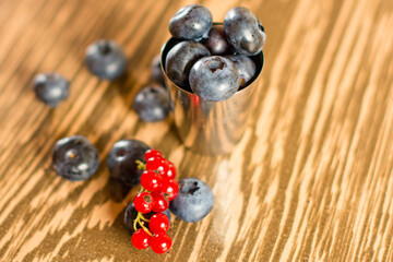 Composition with black and red guide, sweet and healthy summer berries, blueberries and red currants.