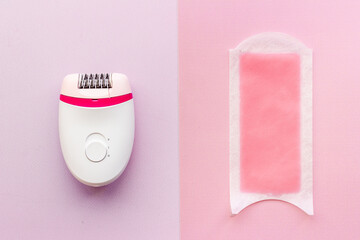 Epilator with pink wax strips. Epilation concept. Top view, flat lay