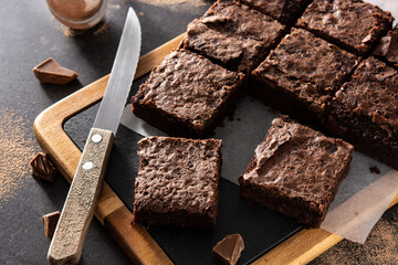 Homemade pieces of brownies on black background	